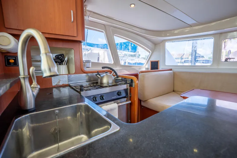 Lovely Cruise Yacht Photos Pics Interior of 2011 Leopard 38 yacht with kitchen and seating area.