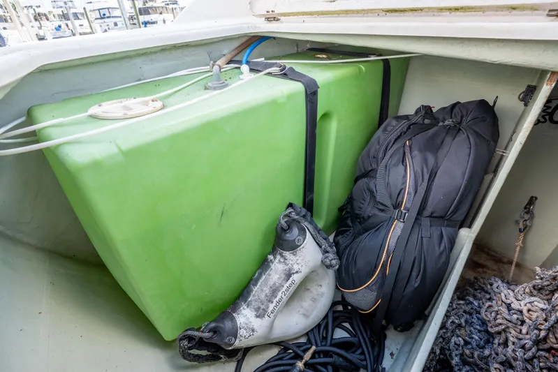 Lovely Cruise Yacht Photos Pics Storage compartment of a 2011 Leopard 38 boat with green tank and gear.