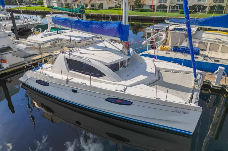 Lovely Cruise Yacht Photos Pics 2011 Leopard 38 catamaran docked in marina, featuring sleek design and blue accents.