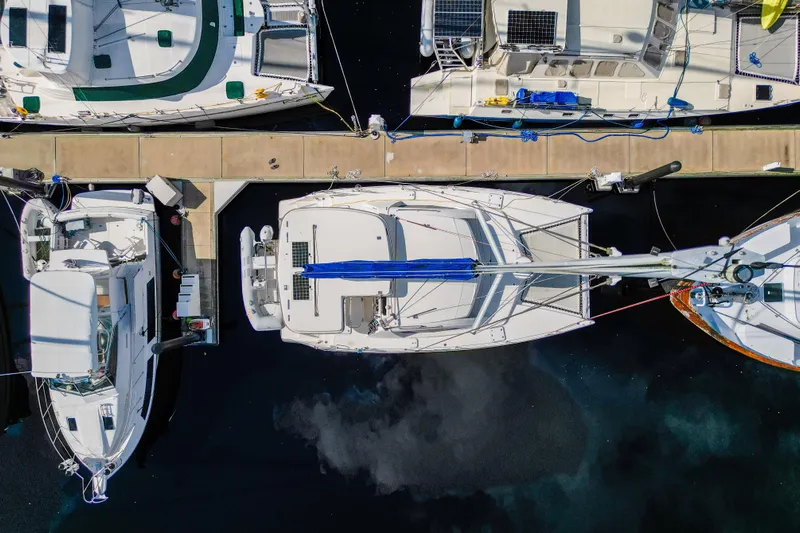Lovely Cruise Yacht Photos Pics Aerial view of a 2011 Leopard 38 catamaran docked among other boats.