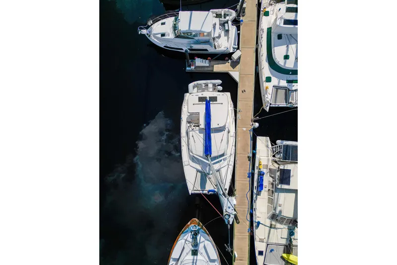 Lovely Cruise Yacht Photos Pics Aerial view of 2011 Leopard 38 catamaran docked among other boats.