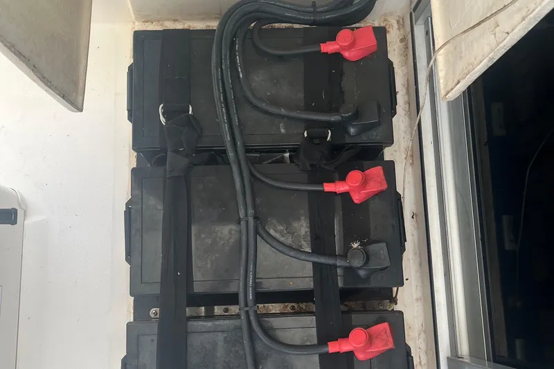 Lovely Cruise Yacht Photos Pics Battery compartment of a 2011 Leopard 38 with connected cables and terminals.