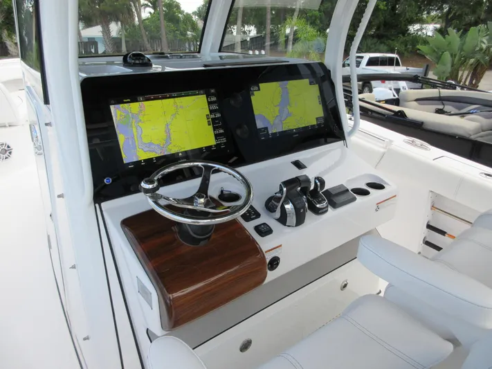 "here We Go" Yacht Photos Pics 2021 Sportsman Open 352 Center Console dashboard with dual navigation screens and steering wheel.