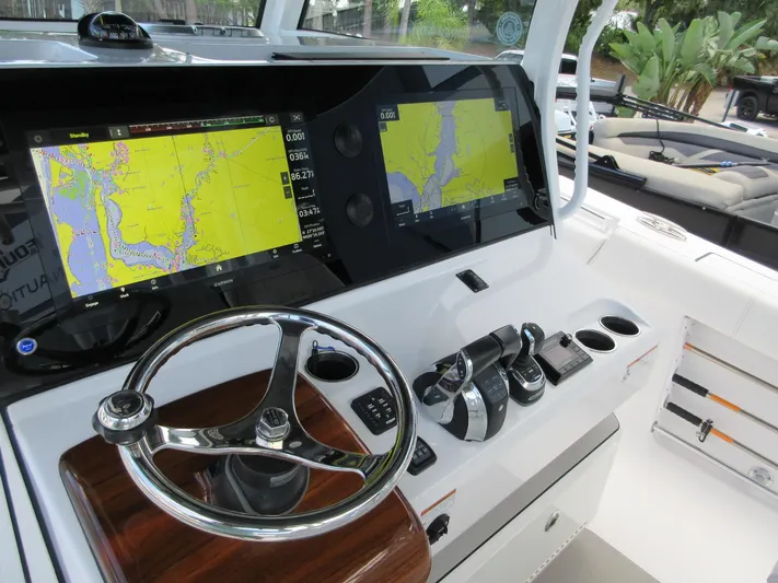 "here We Go" Yacht Photos Pics 2021 Sportsman Open 352 Center Console helm with dual navigation screens and steering wheel.