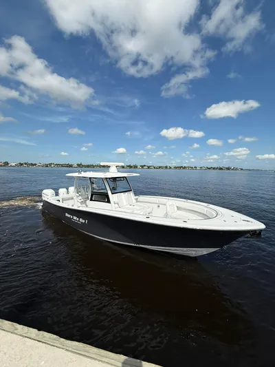 "here We Go" Yacht Photos Pics 2021 Sportsman Open 352 Center Console boat on calm water under a blue sky.