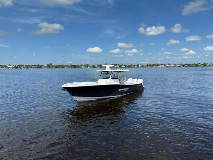 "here We Go" Yacht Photos Pics 2021 Sportsman Open 352 Center Console boat on calm water under blue sky.