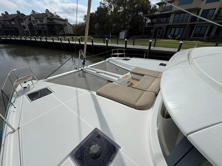 Eden Yacht Photos Pics 2022 Lagoon 46 catamaran docked, featuring spacious deck and comfortable seating.