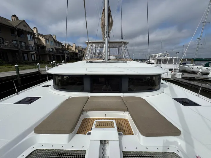 Eden Yacht Photos Pics Lagoon 46 catamaran, 2022 model, docked at marina with spacious deck and seating area.
