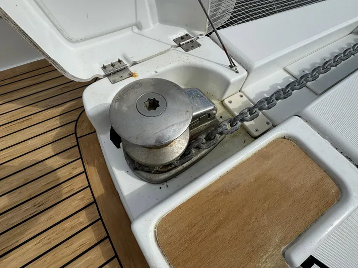 Eden Yacht Photos Pics Anchor winch on 2022 Lagoon 46 yacht deck with chain and wooden flooring.
