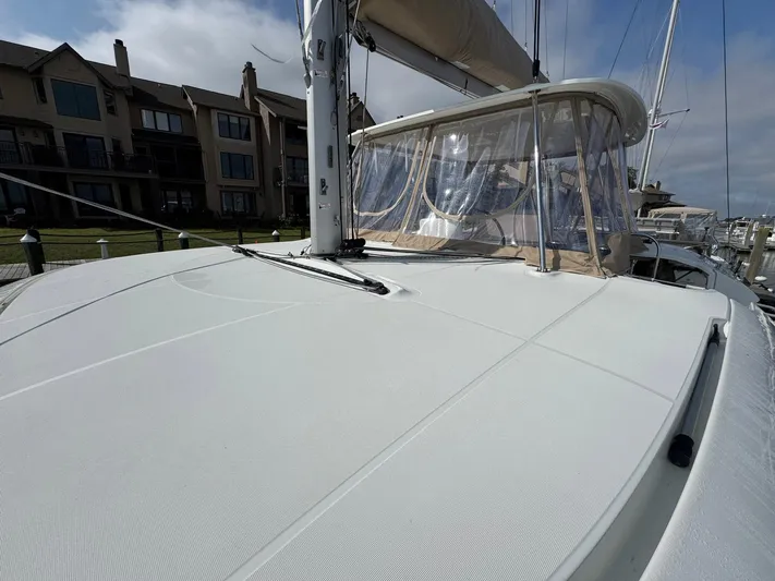 Eden Yacht Photos Pics 2022 Lagoon 46 catamaran docked, showcasing sleek deck design and modern sail features.