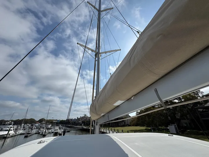 Eden Yacht Photos Pics Lagoon 46 catamaran, 2022 model, docked at marina under a partly cloudy sky.