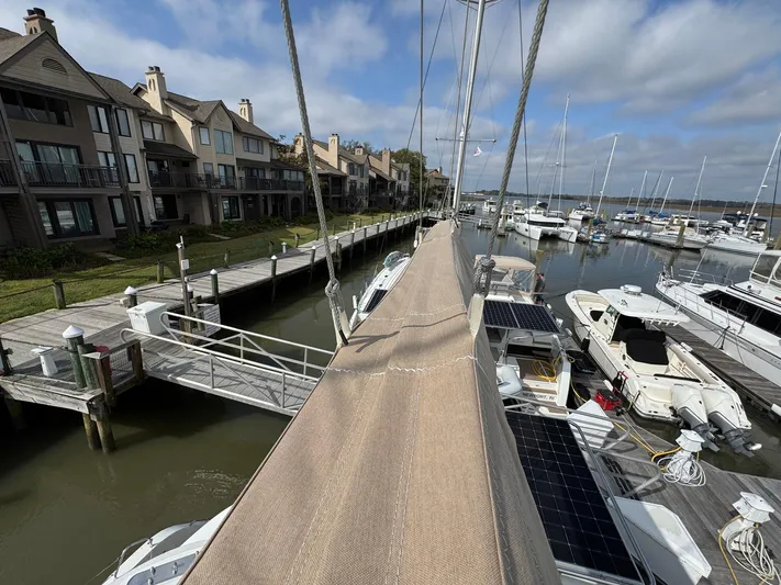 Eden Yacht Photos Pics Lagoon 46 catamaran docked at marina, surrounded by boats and waterfront homes, 2022 model.