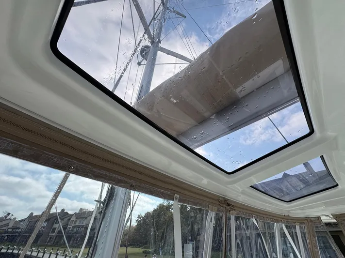 Eden Yacht Photos Pics Interior view of 2022 Lagoon 46 catamaran with skylights and mast visible.
