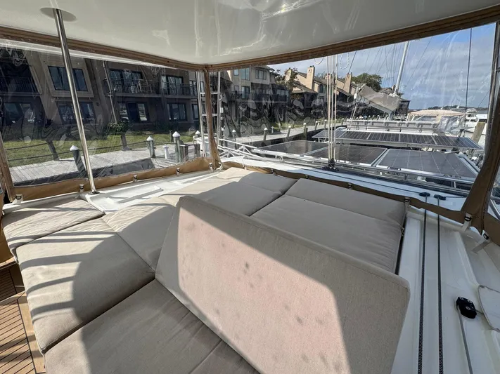 Eden Yacht Photos Pics Luxurious Lagoon 46 catamaran interior, 2022 model, featuring spacious seating and marina view.