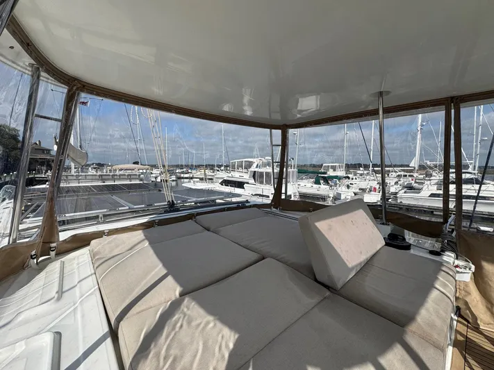 Eden Yacht Photos Pics Luxurious interior of 2022 Lagoon 46 yacht with marina view and comfortable seating.