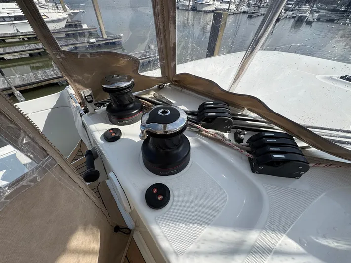 Eden Yacht Photos Pics Helm station of 2022 Lagoon 46 catamaran with winches and ropes, docked at marina.