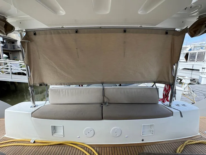 Eden Yacht Photos Pics 2022 Lagoon 46 yacht with cushioned seating and privacy screen on deck.