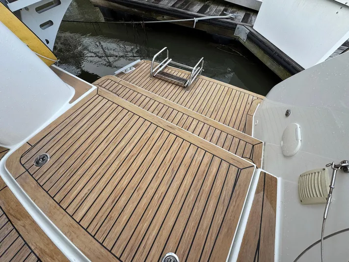 Eden Yacht Photos Pics 2022 Lagoon 46 yacht with teak deck and swim ladder in marina.