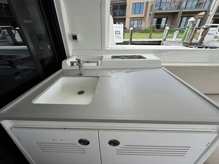 Eden Yacht Photos Pics Outdoor kitchen area on 2022 Lagoon 46 catamaran with sink and stove.