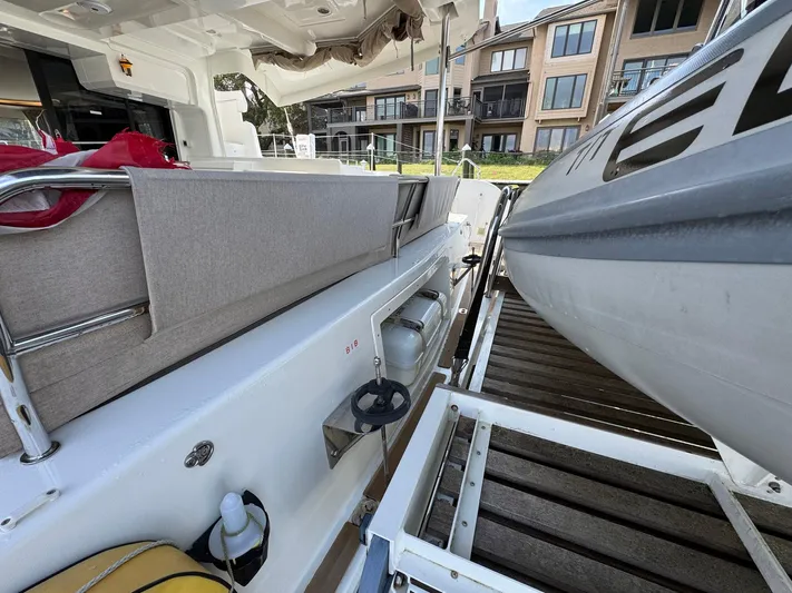 Eden Yacht Photos Pics 2022 Lagoon 46 yacht deck with seating and docked inflatable boat.