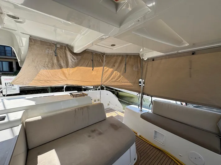 Eden Yacht Photos Pics Spacious interior of 2022 Lagoon 46 yacht with beige seating and sunshades.