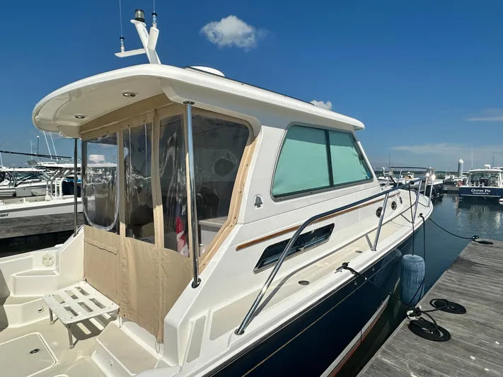 Reveille Yacht Photos Pics 2013 Back Cove 34 boat docked at marina under clear blue sky.