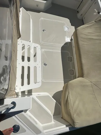 Reveille Yacht Photos Pics 2013 Back Cove 34 boat deck with beige seating and storage compartments.