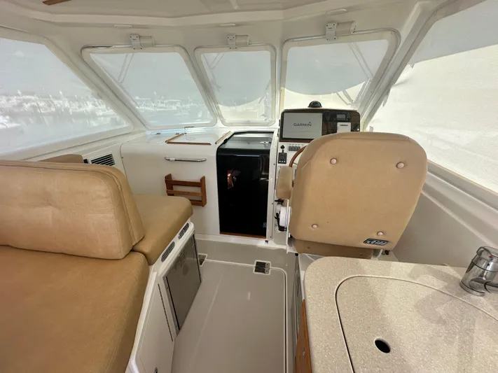 Reveille Yacht Photos Pics 2013 Back Cove 34 interior with helm, seating, and navigation equipment.