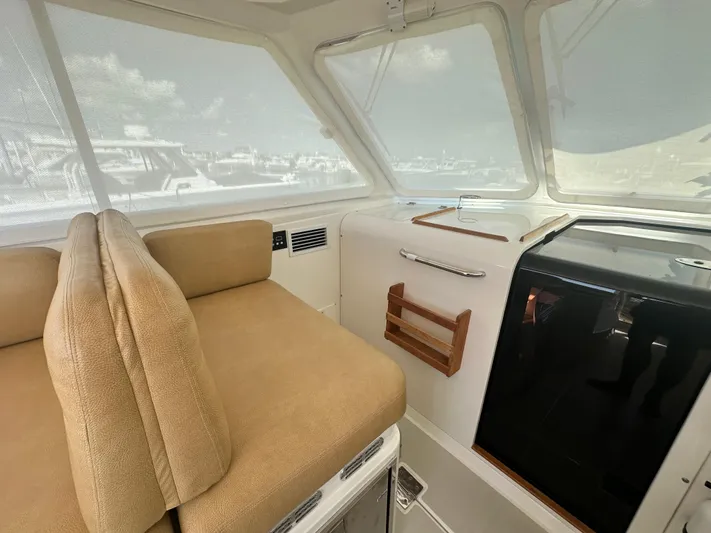 Reveille Yacht Photos Pics Interior of 2013 Back Cove 34 boat with beige seating and modern amenities.