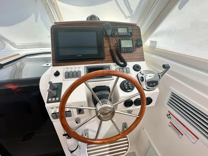 Reveille Yacht Photos Pics Helm of 2013 Back Cove 34 boat with steering wheel and navigation equipment.