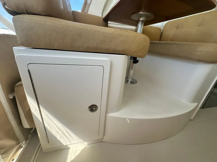 Reveille Yacht Photos Pics 2013 Back Cove 34 interior seating with storage compartment and table.