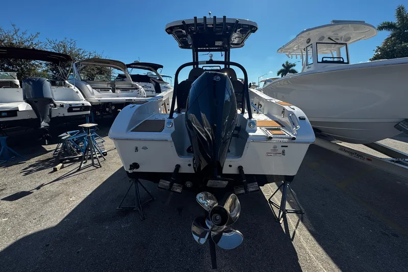 Yacht Photos Pics 2026 Sea Pro 245FLX Sandbar boat with powerful outboard motor, parked outdoors.