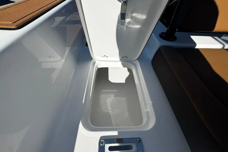  Yacht Photos Pics Storage compartment on 2026 Sea Pro 245FLX Sandbar boat, open lid, white interior.