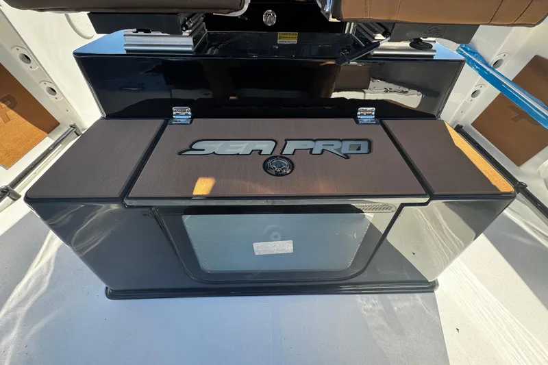  Yacht Photos Pics 2026 Sea Pro 245FLX Sandbar boat interior with branded storage compartment.
