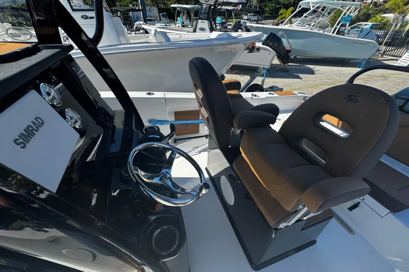  Yacht Photos Pics 2026 Sea Pro 245FLX Sandbar boat interior with steering wheel and seating.