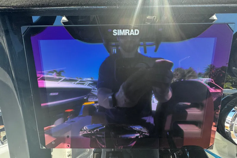 Yacht Photos Pics Simrad display on 2026 Sea Pro 245FLX Sandbar boat, reflecting surroundings.