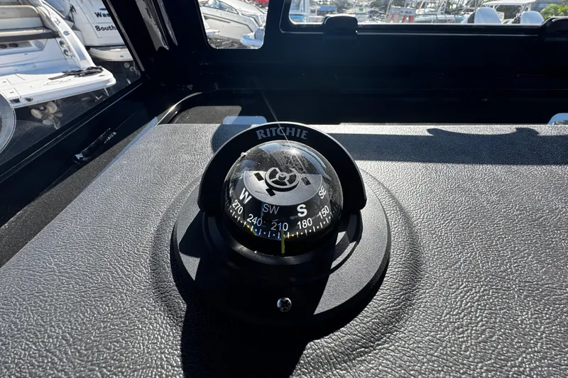  Yacht Photos Pics Compass on 2026 Sea Pro 245FLX Sandbar boat dashboard, surrounded by other boats.