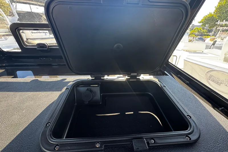  Yacht Photos Pics Open storage compartment on 2026 Sea Pro 245FLX Sandbar boat, showcasing interior space.