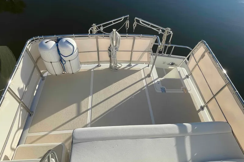 Free Ride Yacht Photos Pics 2002 President Trawler deck with railings and fenders, sunlit and spacious.