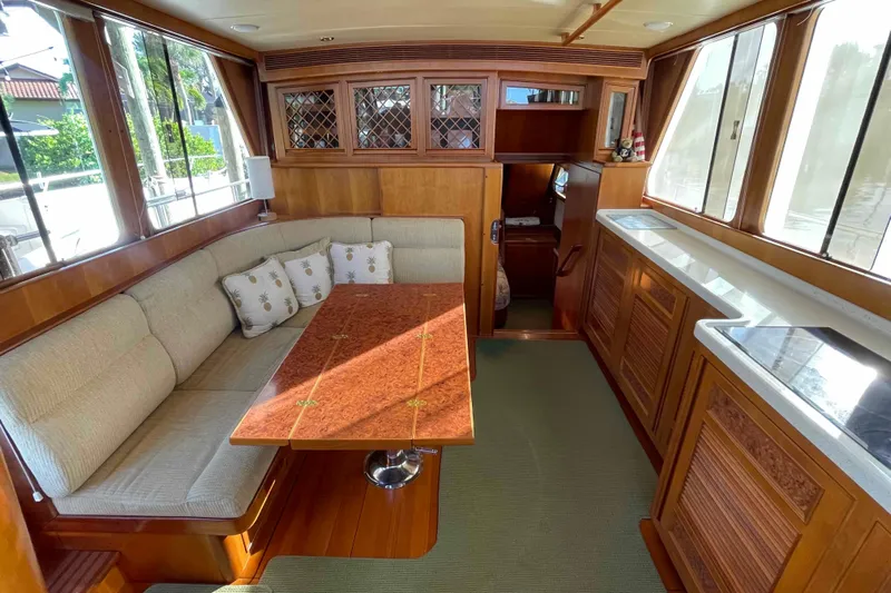 Free Ride Yacht Photos Pics Luxurious 2002 President Trawler interior with elegant wood finishes and cozy seating area.