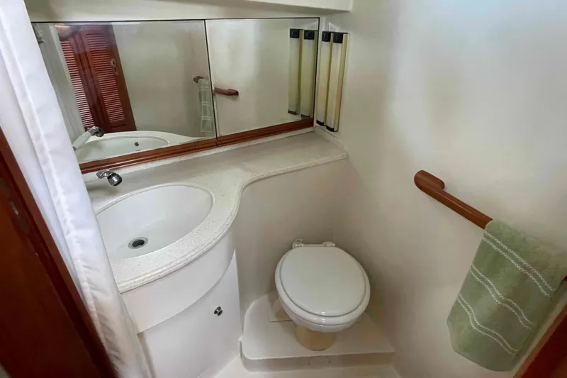 Free Ride Yacht Photos Pics Compact bathroom in 2002 President Trawler with sink, toilet, and mirror.