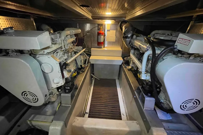 Free Ride Yacht Photos Pics Engine room of a 2002 President Trawler with dual engines and fire extinguisher.