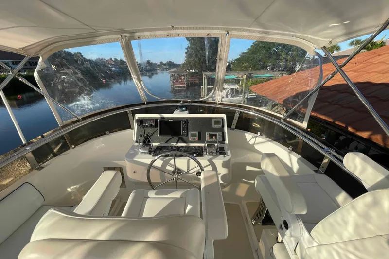 Free Ride Yacht Photos Pics Helm of 2002 President Trawler with modern controls, overlooking serene waterway.