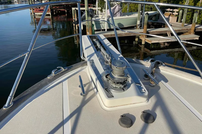 Free Ride Yacht Photos Pics Bow of a 2002 President Trawler boat with anchor winch, docked at marina.