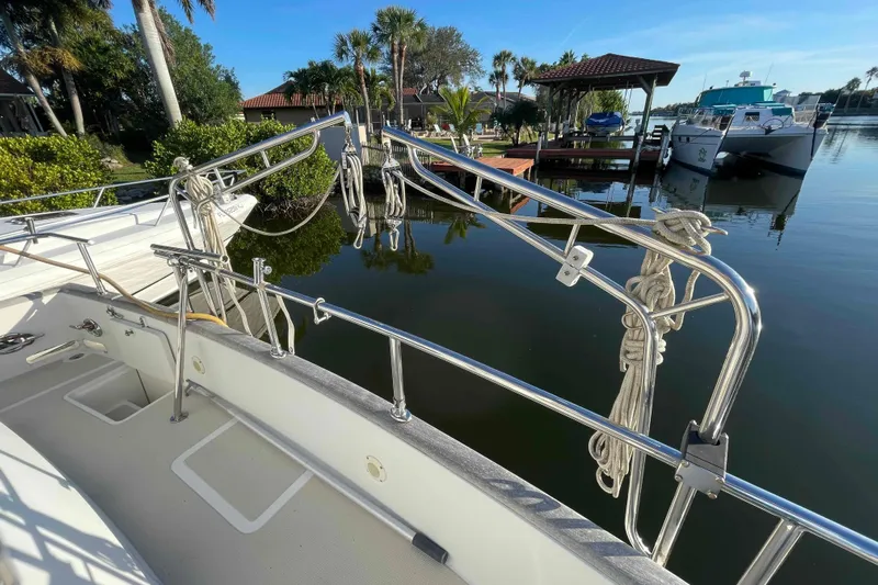 Free Ride Yacht Photos Pics 2002 President Trawler docked by a serene waterfront with lush greenery.