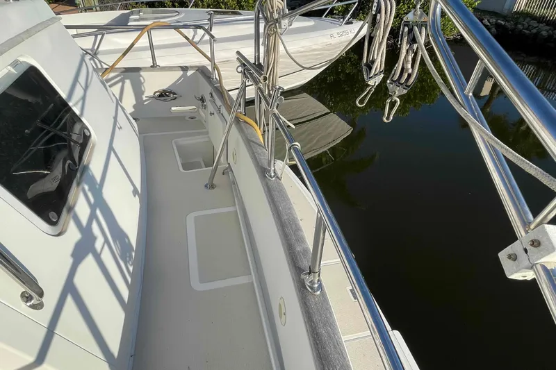 Free Ride Yacht Photos Pics 2002 President Trawler boat deck with railing, docked near calm water.