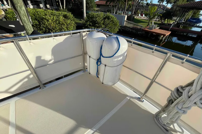 Free Ride Yacht Photos Pics 2002 President Trawler deck with fenders and ropes, docked near lush greenery.