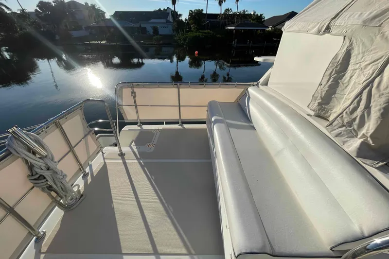 Free Ride Yacht Photos Pics 2002 President Trawler deck with seating, overlooking serene waterfront view.