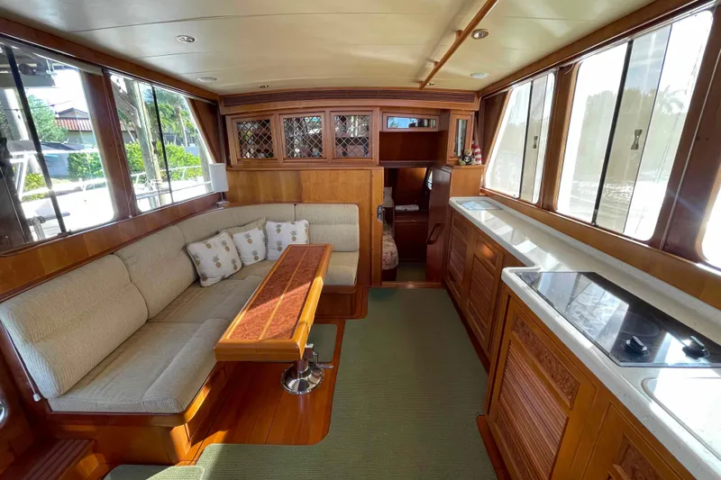 Free Ride Yacht Photos Pics Luxurious interior of a 2002 President Trawler yacht with elegant wood finishes and cozy seating.