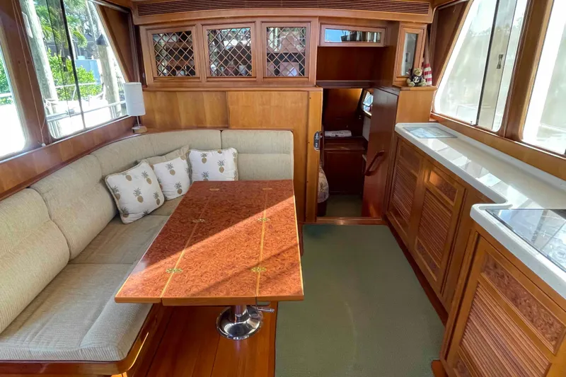 Free Ride Yacht Photos Pics Cozy interior of 2002 President Trawler with wood accents and cushioned seating.